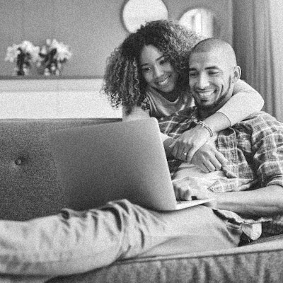 Happy couple looking over documents online