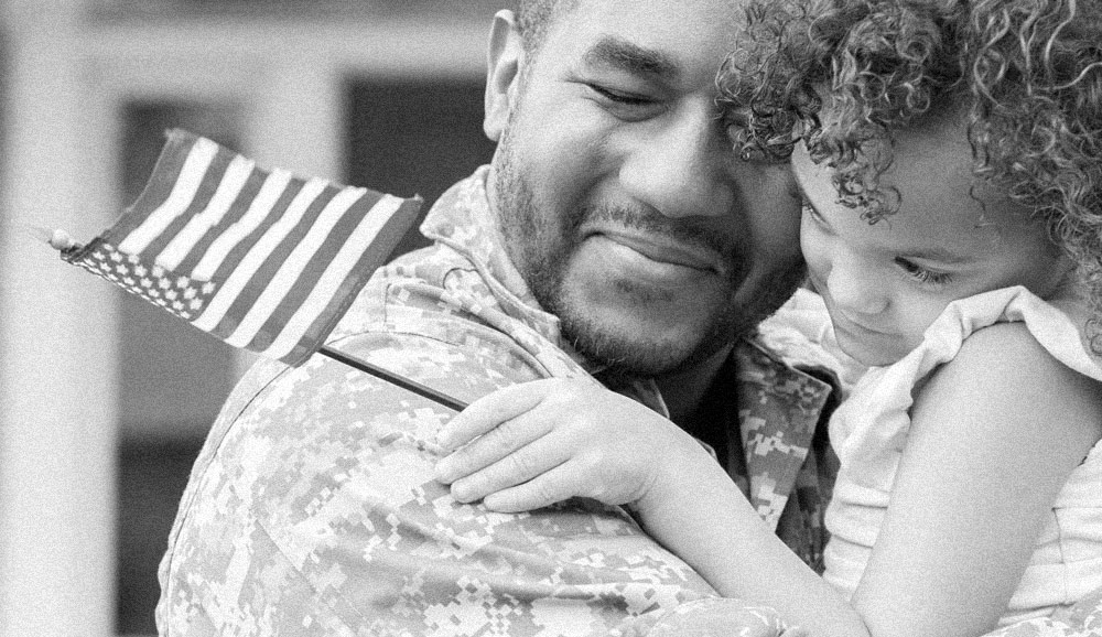 United States soldier happily embracing his daughter